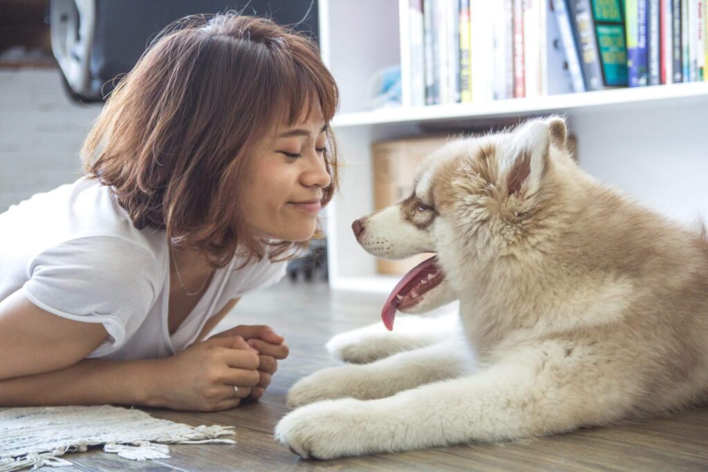 Woman and dog looking at each other