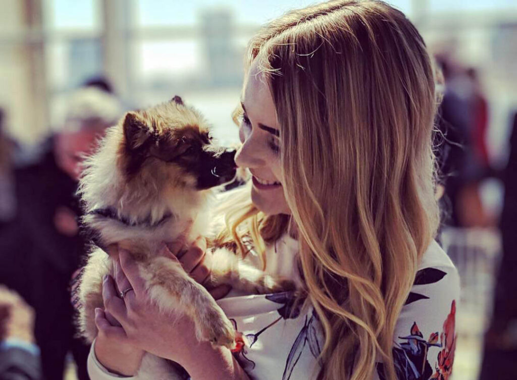 Woman with dog at Michigan Humane's Purrfect Bow Wow Brunch.
