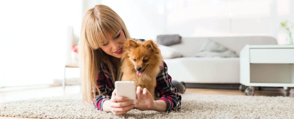 Woman and her dog using telemedicine.