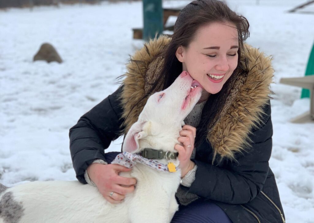 Michigan Humane volunteer with dog in the snow.